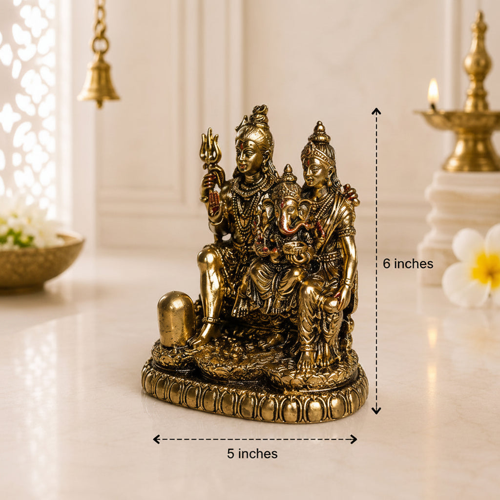 A small bronze-colored Hindu deity statue shown on a light surface with overlaid dimension arrows and text reading 6 inches tall and 5 inches wide. The background is softly blurred with decorative objects and warm indoor lighting.